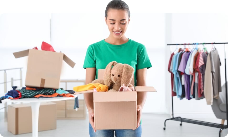 volunteer with box of donations