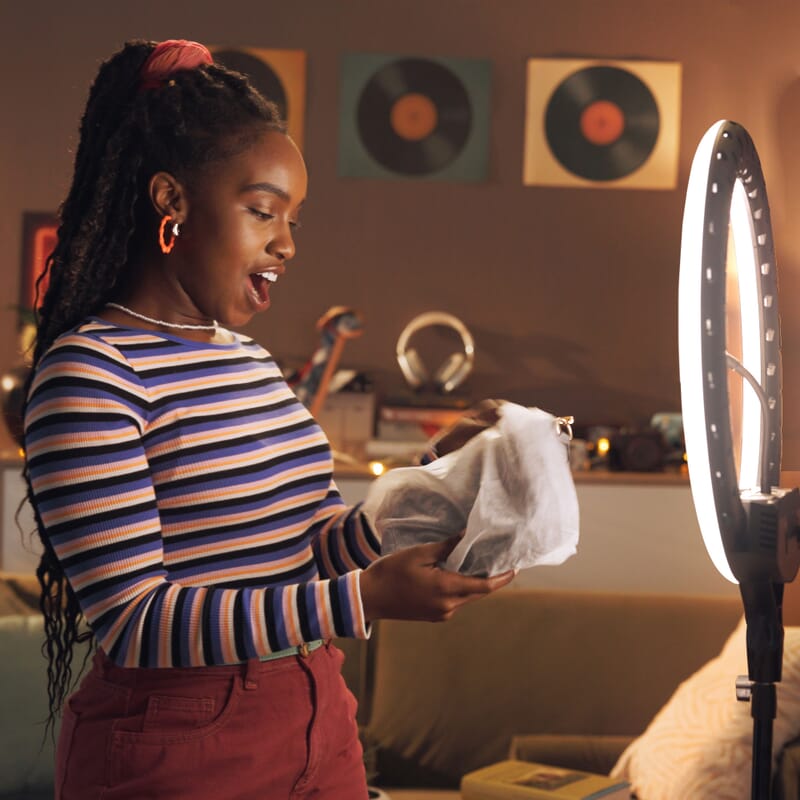 influencer opening gift from business to promote small business saturday