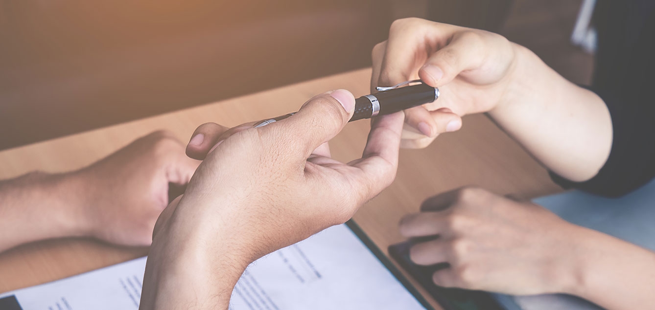 People sharing a pen