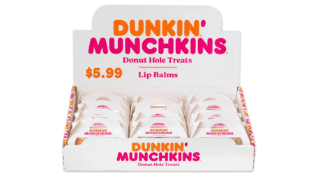 Twelve Dunkin lip balms in a white display box with orange and pink text