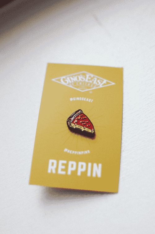 Enamel pin shaped like a slice of deep dish pizza