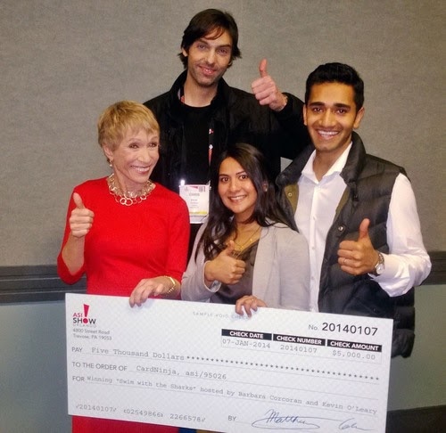 The inventors of the CardNinja accepting a check for $5,000 from Shark Tank investors.