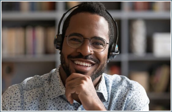 Man wearing headphones and attending online meeting