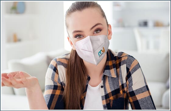 Woman wearing a custom face mask and attending online meeting