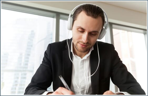 Man writing with logoed pen