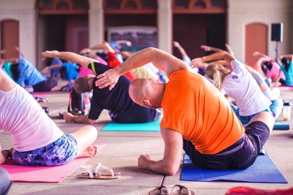 People stretching on yoga mats during a group yoga class