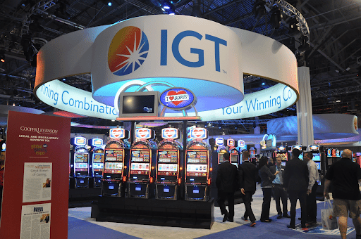 Large booth for the company International Game Technology (IGT) with several lit-up slot machines