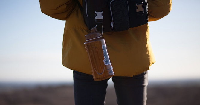 Man Hiking with Orange Water Bottle
