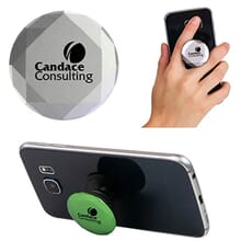 Silver geometric cut PopSockets phone grip with black logo attached to back of black smartphone