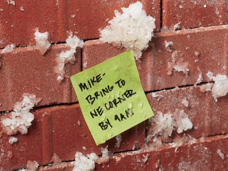Snowy brick wall labeled with a Post-it Extreme Sticky Note