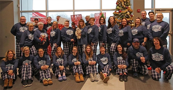 Crestline employees wearing custom pjs for a holiday party