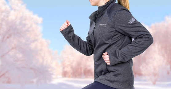 Woman running wearing custom northface athletic top