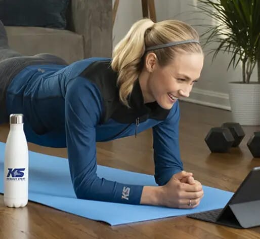woman exercising from home with fitness giveaways