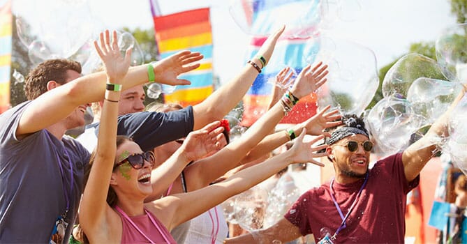 Fun outdoor event with sunglasses, lanyards, bubbles, and flags