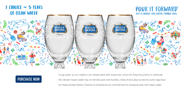 Three glass Stella Artois-branded chalices with gold rims and blue logos against a colorful background