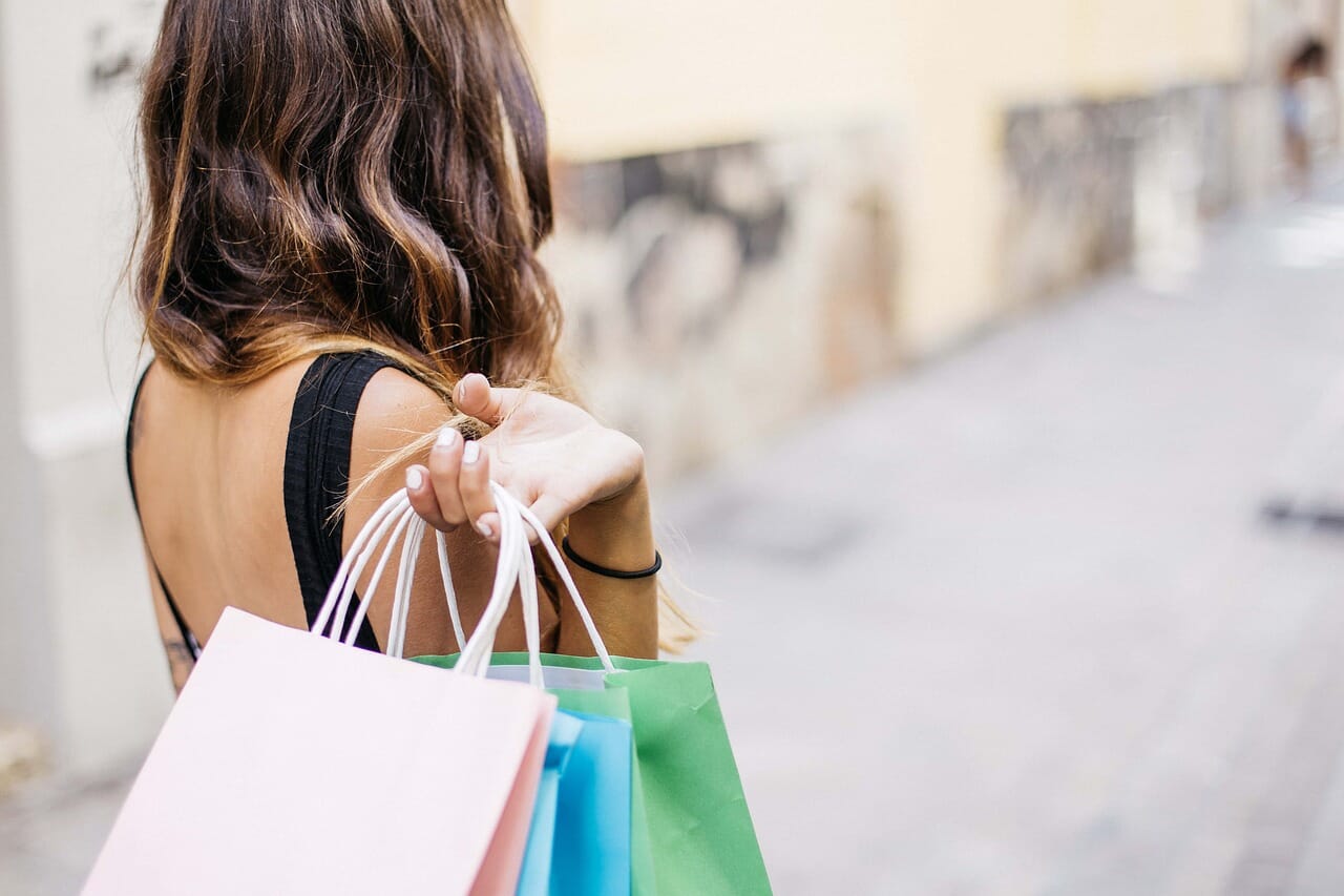 Woman holding multiple paper gift bags