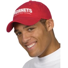 Man wearing custom red baseball cap