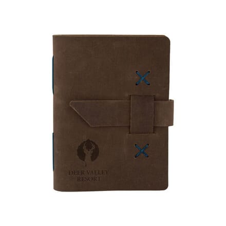 Brown leather notebook with debossed logo and snap closure