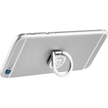 Silver aluminum phone ring with engraved logo attached to and propping up silver iPhone